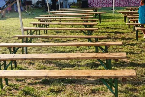 Row of empty benches at an event in the park Stock Photos