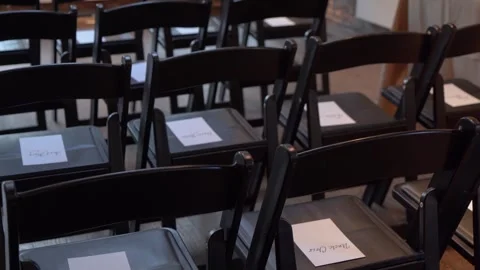 A row of empty chairs beautifully arranged and ready to welcome guests for an Video stock 291026296
