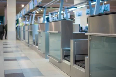 Row of empty check-in desks with computers in airport Stock Photos