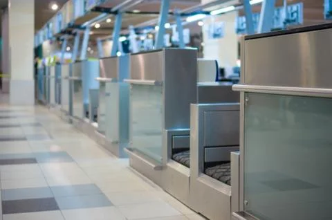 Row of empty check-in desks with computers in airport Stock Photos