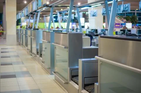 Row of empty check-in desks with computers in airport Stock Photos