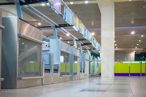 Row of empty check-in desks with computers in airport Stock Photos