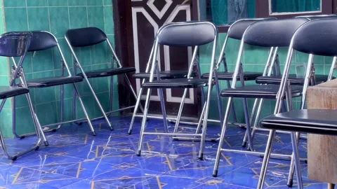 Row of empty folding chairs in a waiting area Stock Footage 337570310