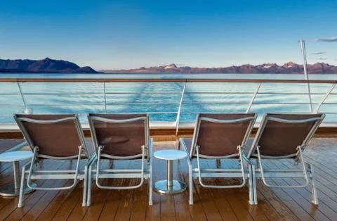 Row of empty plastic cruise ship deck lounge chairs early morning, Alaska, USA. Stock Photos