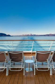 Row of empty plastic cruise ship deck lounge chairs early morning, Alaska, USA. Stock Photos