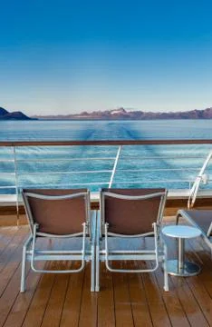 Row of empty plastic cruise ship deck lounge chairs early morning, Alaska, USA. Stock Photos