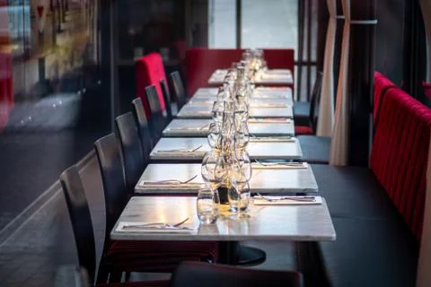 Row of empty restaurant tables with chairs Stock Photos