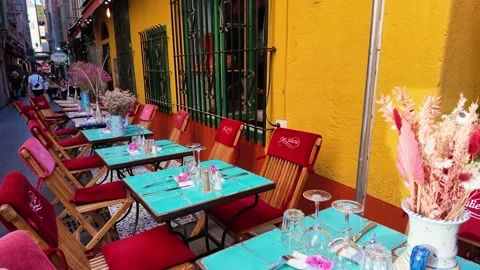 Row of empty restaurant tables on a narrow street Stock Footage 336922609
