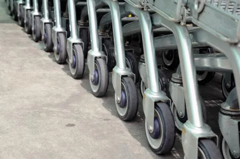 Row of empty shopping carts in big supermarket Stock Photos