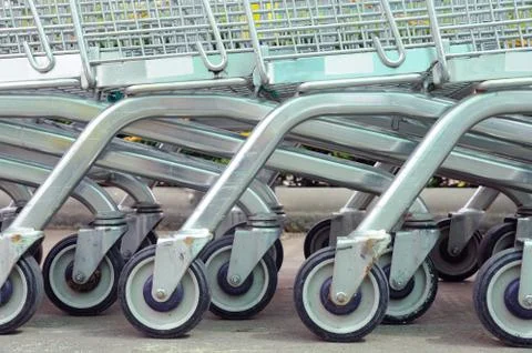 Row of empty shopping carts in big supermarket Stock Photos