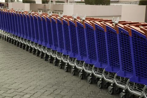 Row of empty shopping carts in the big supermarket Stock Photos