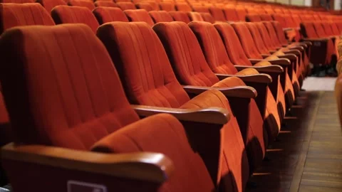 Row of empty spectator chairs with raised seats in an empty auditorium Stock Footage 274673548