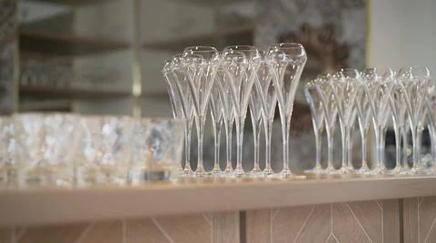 Row of empty wine glasses on bar counter. Beautiful wine glasses on the bar t Stock Photos