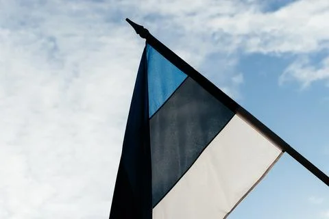 A row of Estonian flags waves in the winter sun, decorating a historic Stock Photos