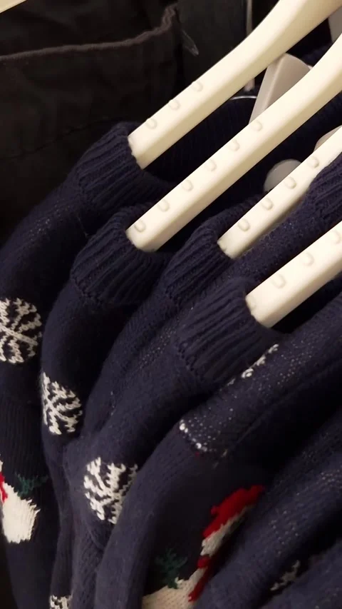 Row of Festive Christmas Sweaters Displayed for Sale Stock Footage 326061291