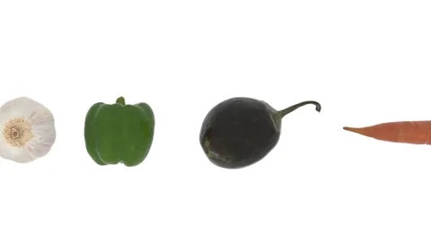 A row of fine ripe vegetables moving from right to left on a white background Stock Footage 148289495