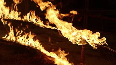 Row of flames at night Stock Footage 324516636