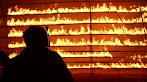 Row of flames at night Stock Footage 324519951