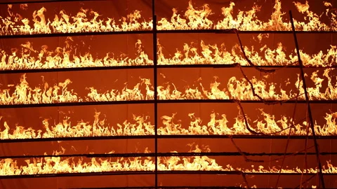 Row of flames at night Stock Footage 324519957