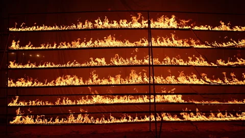 Row of flames at night Stock Footage 324520094