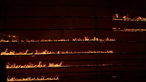 Row of flames at night Stock Footage 324520425