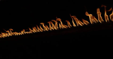 Row of flames at night Видео 324522729