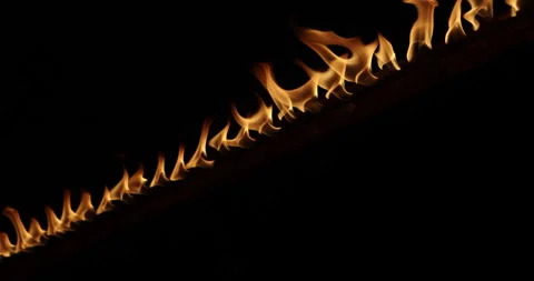 Row of flames at night 스톡 동영상 324523090
