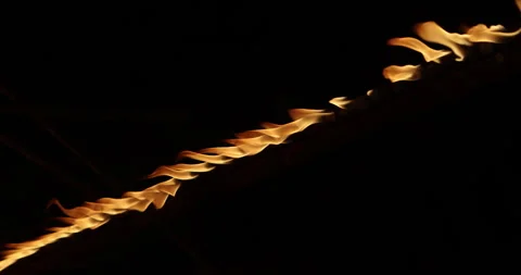 Row of flames at night Stock Footage 324523401