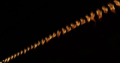 Row of flames at night Stock Footage 324523491