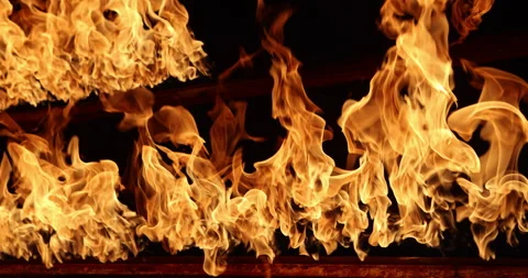 Row of flames at night 스톡 동영상 324523617