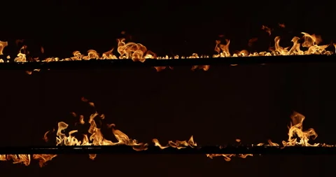 Row of flames at night Stock Footage 324523995