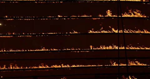 Row of flames at night Stock Footage 324524006