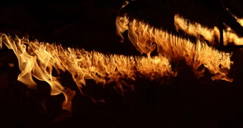 Row of flames at night Stock Footage 324524285