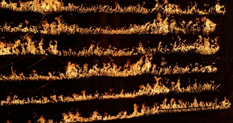 Row of flames at night Stock Footage 324525876