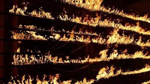 Row of flames at night 스톡 동영상 324526211