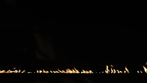 Row of flames at night Stock Footage 324528736