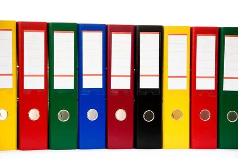 Row of folders for papers and documentation on a shelf in the office Stock Photos