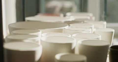 Row of Freshly Molded Ceramic Pots Drying in Sunlit Workshop Stock-Footage 275835130