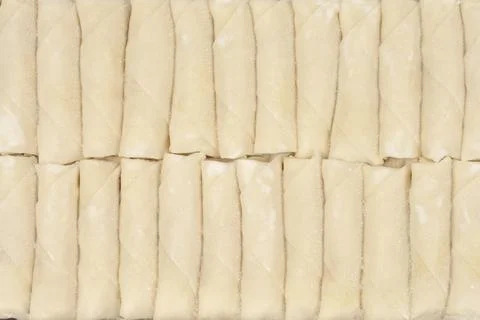 Row of frozen spring rolls pattern Foto stock
