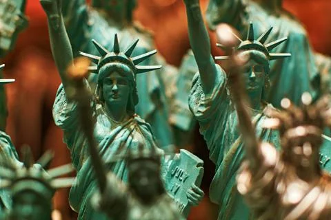 Row with generic Statue of Liberty statues sold as souvenirs in a NYC shop - Stock Photos