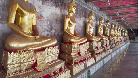 Row of gilded Buddha statues in Wat Suthat Thepwararam, Bangkok Stock Footage 274633845