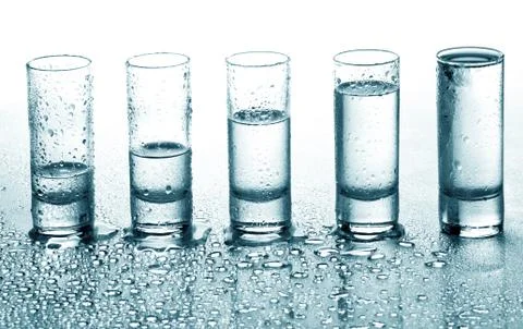 A row of glasses for vodka Stock Photos