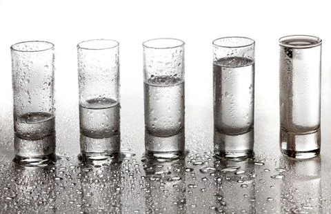 A row of glasses for vodka Stock Photos