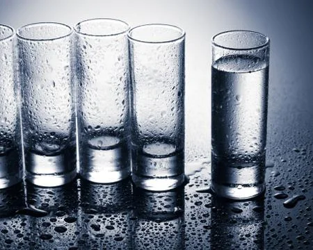 Row of glasses for vodka Stock Photos