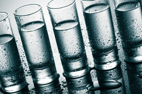 Row of glasses for vodka Stock Photos