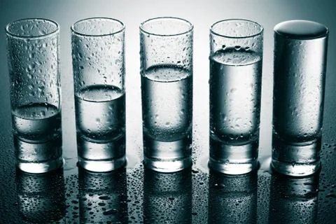 Row of glasses for vodka Stock Photos