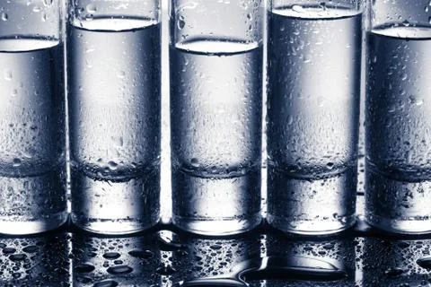 Row of glasses for vodka Stock Photos
