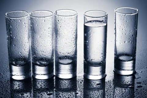 Row of glasses for vodka Stock Photos