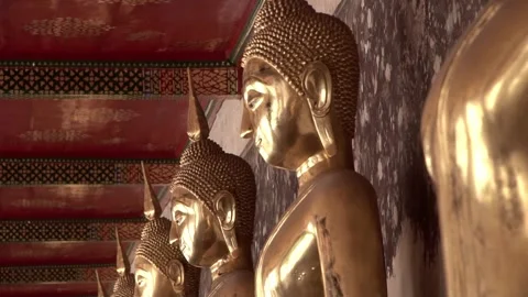 Row of golden Buddhas in a Buddhist temple in slow motion. Stock Footage 312983765