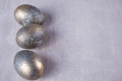 Row of gray Easter eggs on gray wooden background. Copy space. Stock Photos